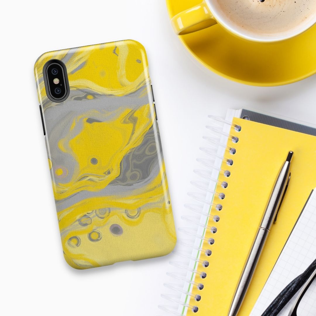 Zest Yellow & Grey Abstract Fluid Art iPhone Case fro artist Louise Mead next to up of coffee and note book plus pen flatlay style